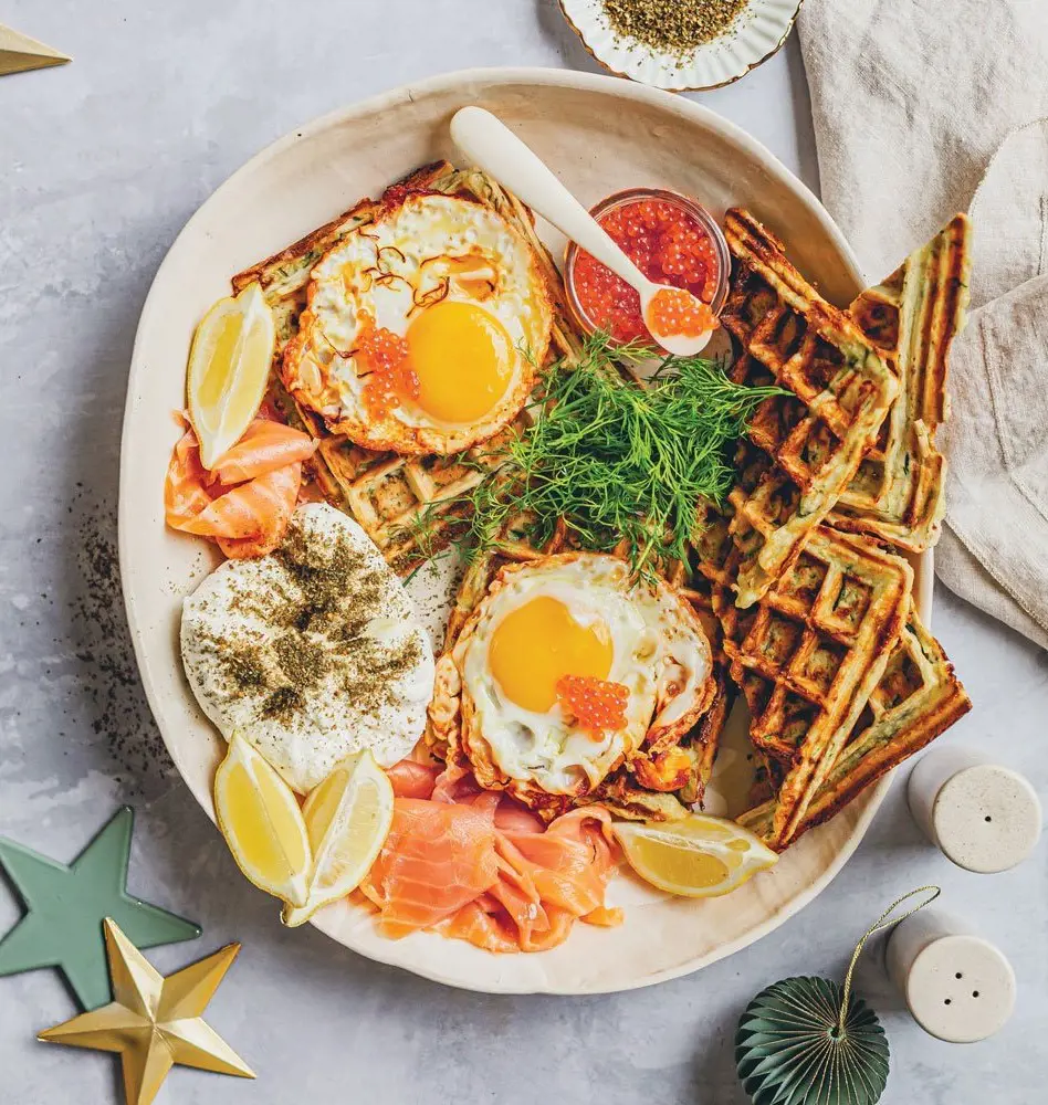 Zucchini waffles with halloumi, eggs and smoked salmon is usually enjoyed during Christmas ocassion.