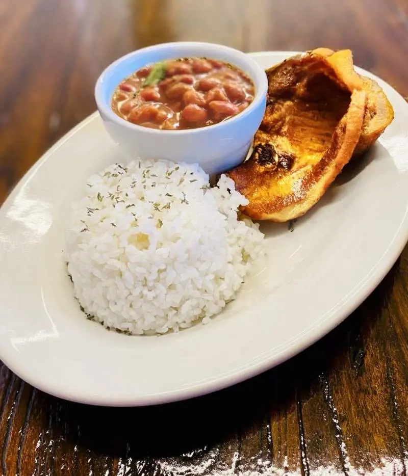 This culinary delight is usually made with white rice, beans, sofrito, tomato sauce, and seasonings