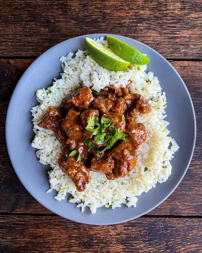 Delicious carne guisada served with cilantro lime rice